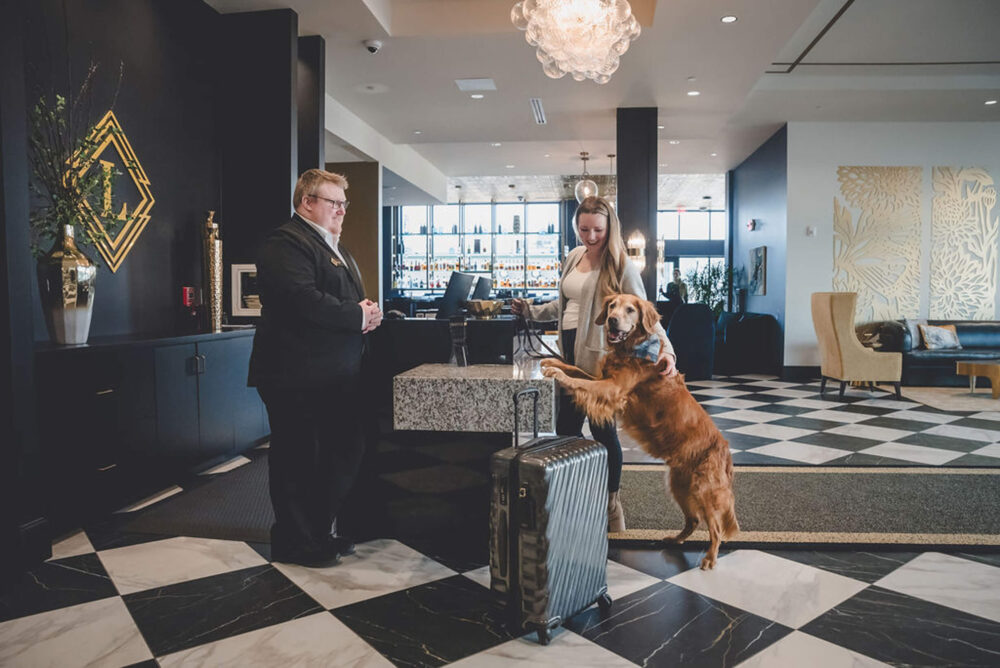 Photo of dog and woman at front desk