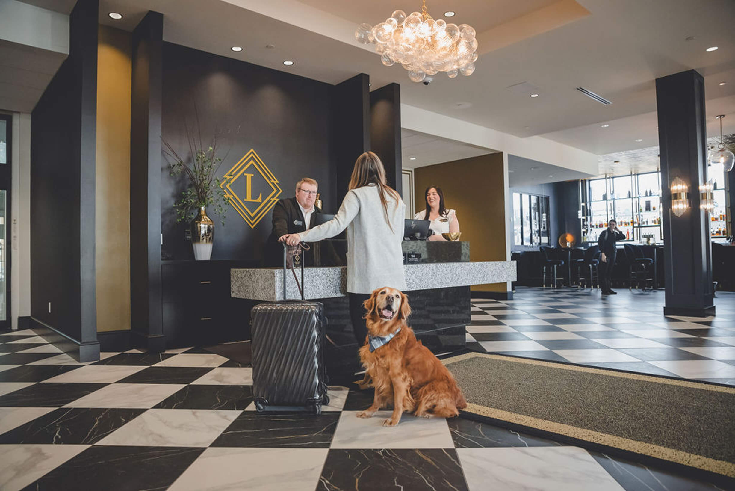 Photo of dog and woman at front desk